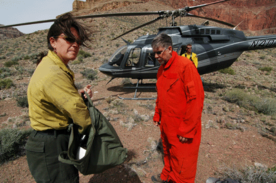 Jessica assisting Dennis with his flight suit