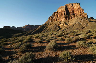 Geikie Peak in the early morning light with Scylla Butte in silhouette (far left) in the distance