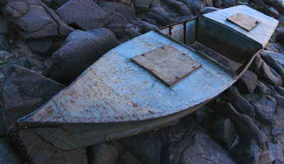 The Ross Wheeler rests on boulders above the Colorado River below Bass Beach