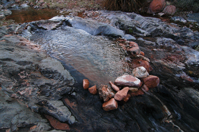 A manmade dam pools water in Boucher Creek