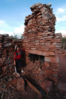 Standing next to the fireplace in the cook's cabin