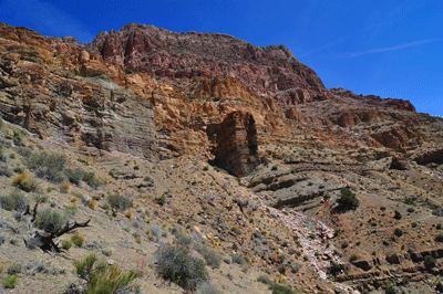 An isolated column of stone stands sentry along Nankoweap trail