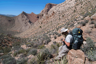 Rob pauses the check his GPS along the ascent route out of Awatubi Canyon