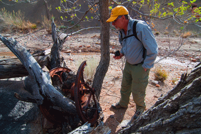 Dennis inspects the old coffee mill at the Lava Creek Still Spring