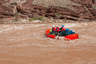 A river party runs Nevills Rapids