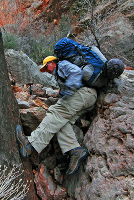 Dennis squeezes through a narrow section