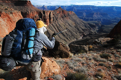 Dennis points toward Lyell Butte across the Colorado River